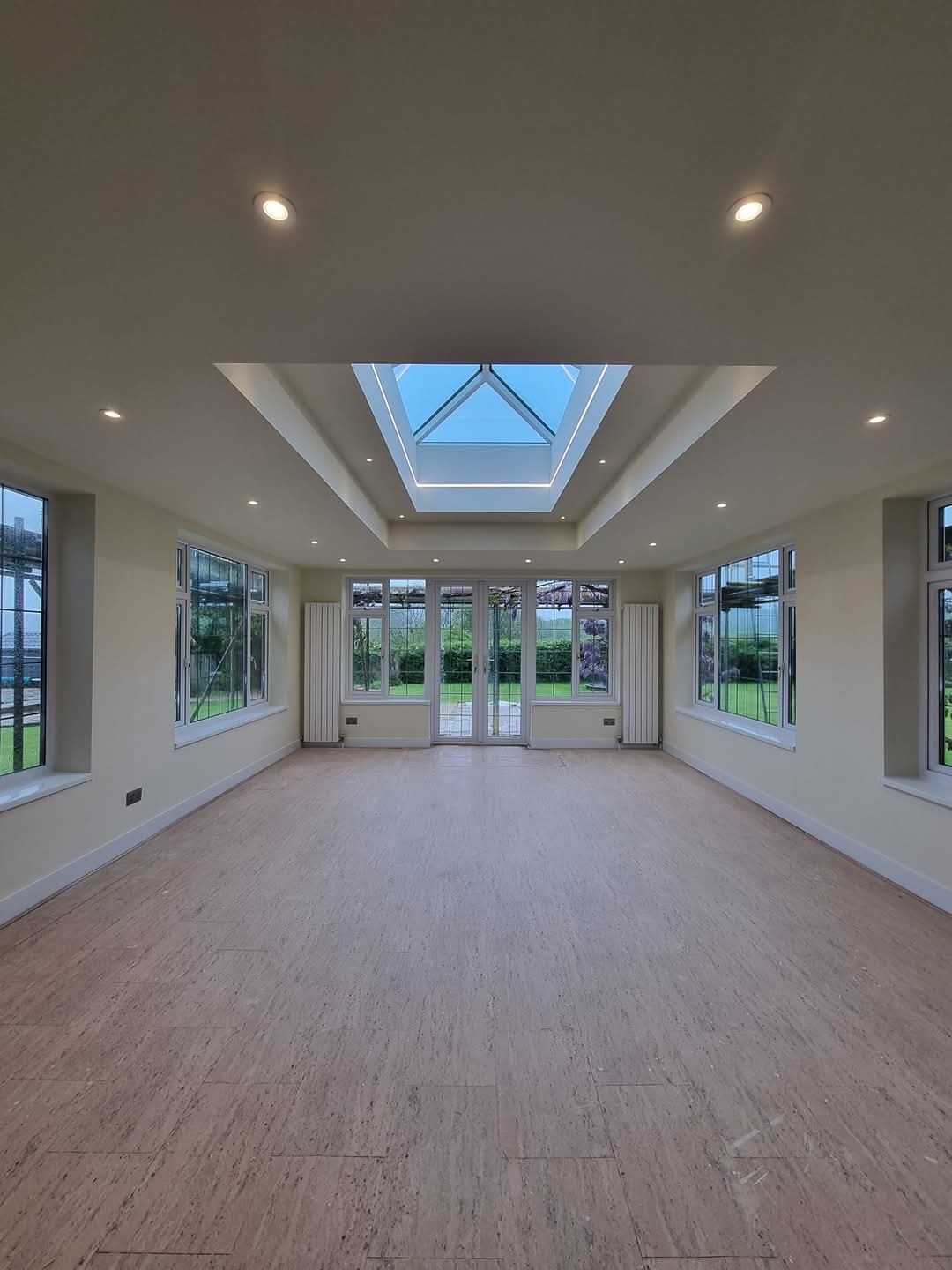 Large room with recessed downlights around a roof lantern