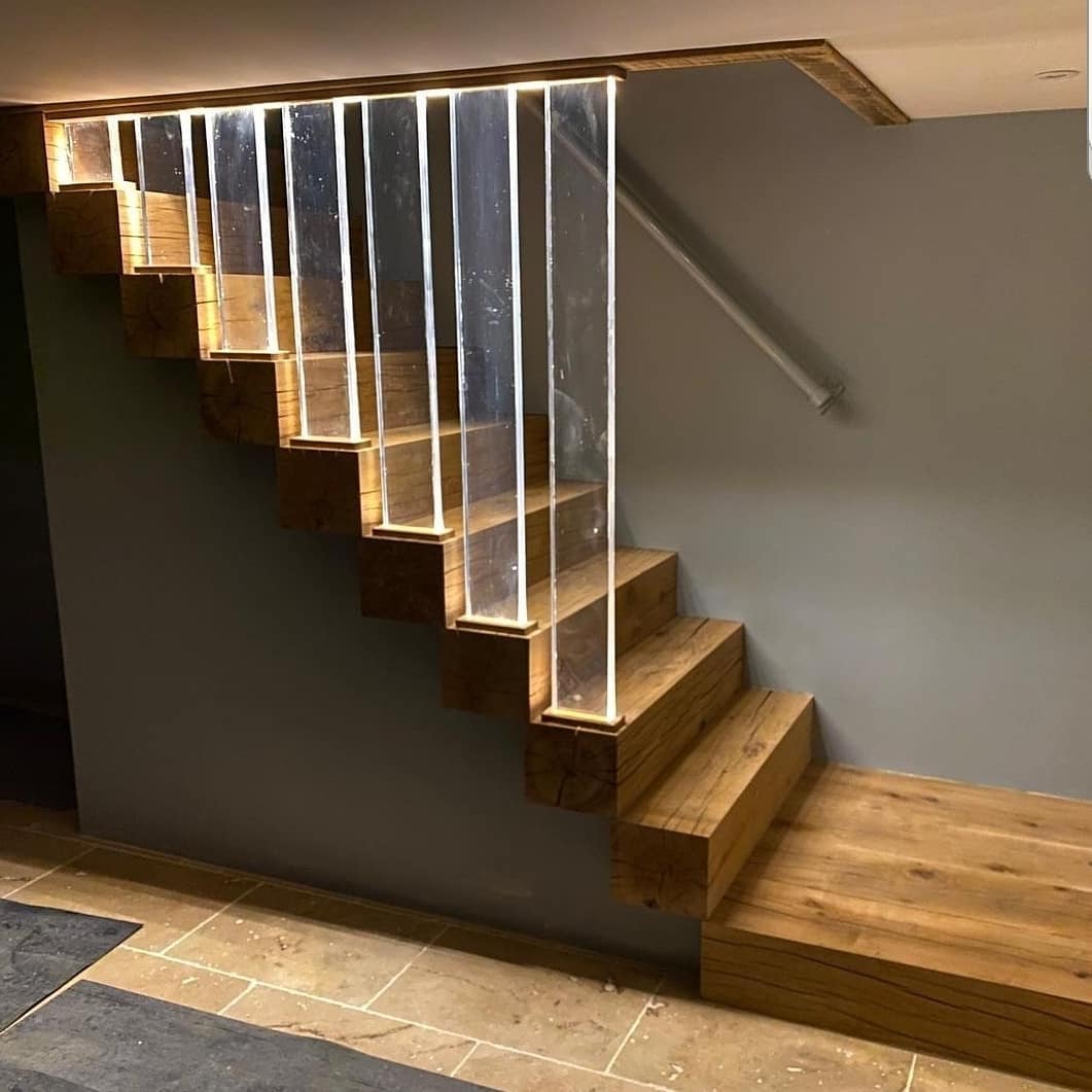 Oak staircase with LED lighting running through a glass balustrade