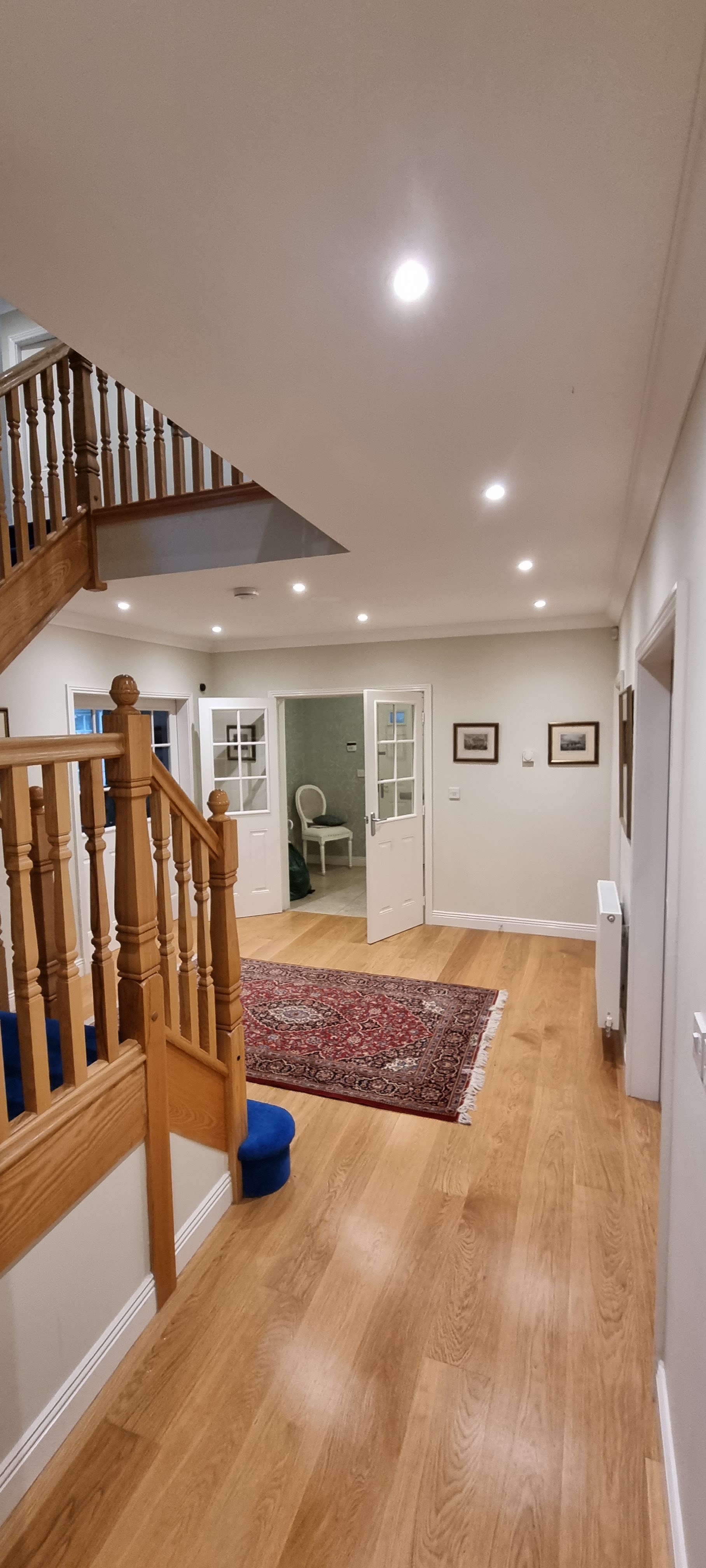Hallway with recessed downlights, oak floor and staircase, wired by Nectar Electrical